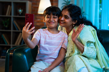 Indian Child and mom video calling on smartphone, showing love, bonding, and happy family moments