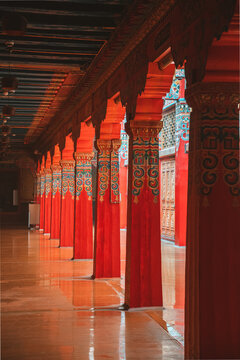 View of vibrant red pillars standing in a row create a striking visual rhythm and cultural richness, Di Qing Zang Zu Zi Zhi Zhou, Yun Nan Sheng, China.