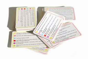 Playing cards in a quiz game on an isolated white background
