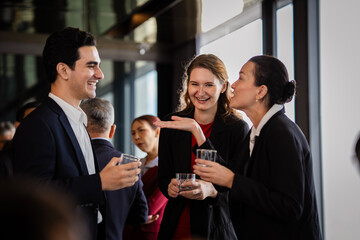 Professionals meeting at an evening event, emphasizing collaboration, leadership, and organizational values. Business people relaxed talk at party on rooftop restaurant.