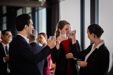 Corporate employees meeting at a social party, blending business discussions with fun networking in a modern workplace environment.