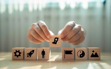 A person's hands build a strategic business plan with wooden blocks, representing the concept of growth, vision, and a successful rocket launch