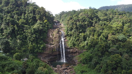 A tropical waterfall in a mountain canyon. Tropical Aberdeen Falls in mountain jungle, Sri Lanka. Waterfall in the tropical forest.