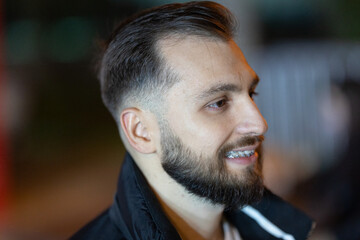 Obraz premium Young smiling man showing dental braces on teeth