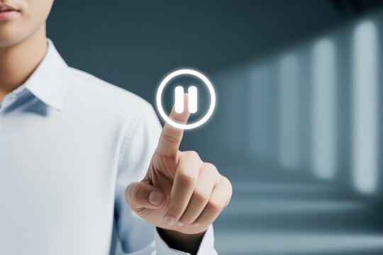 A businessman's hand pressing a virtual pause button on a digital interface, symbolizing the concept of taking a break or stopping a process