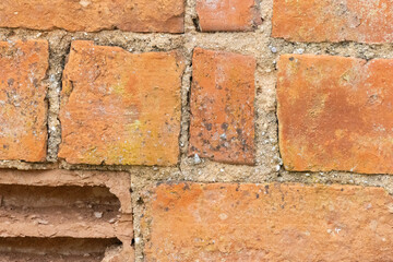 Damaged brick wall showing signs of age and wear