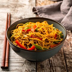 Stir-fried noodles with colorful vegetables in a bowl
