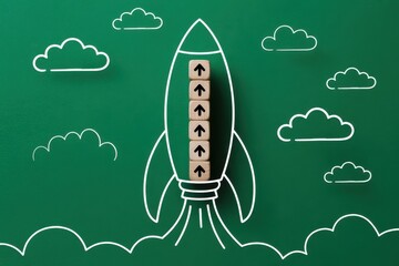 Creative concept of a business startup launching for success, with a chalk rocket and wooden blocks showing an upward trend of growth and development