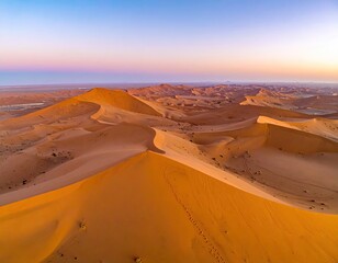 Desert dunes under colorful sky at sunset