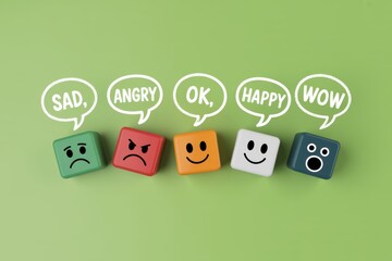 Colorful wooden blocks displaying a range of emotions from sad and angry to happy and wow for customer feedback