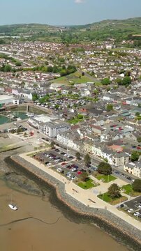 Rising social ratio aerial video aerial GV of Warrenpoint in County Down, Northern Ireland on a bright and sunny day. Produced in 1080x1920, 60FPS and with Rec709 color.