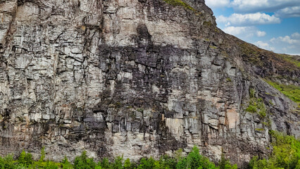 A rocky mountain with a large rock formation that looks like a person