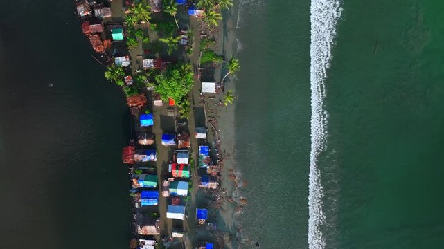 Wewak bay East Sepik Province Madang Papua New Guinea aerial drone PNG Birdseye view coastal neighborhood village town buildings Pacific Ocean pristine untouched beach coastline shore waves forward