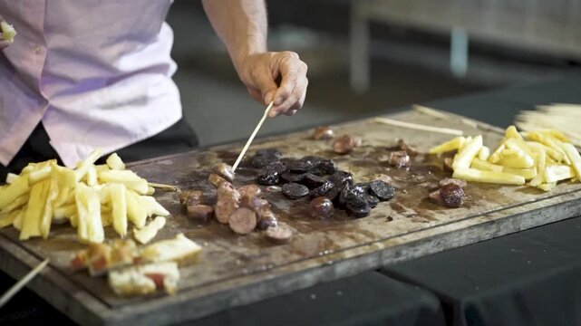 Appetizer board from Argentine asado with grilled pork sausage, blood sausage, fries, and bread bites&mdash;served rustic-style for communal sharing in a casual barbecue setting