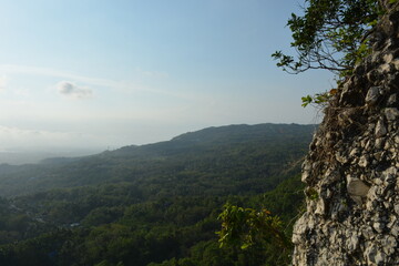 Scenic Hillside Landscape with Coastal Horizon and Dramatic Sky