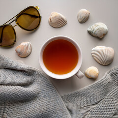 Winter Meets Summer – Cozy Tea with Seashells and Sunglasses Flat Lay