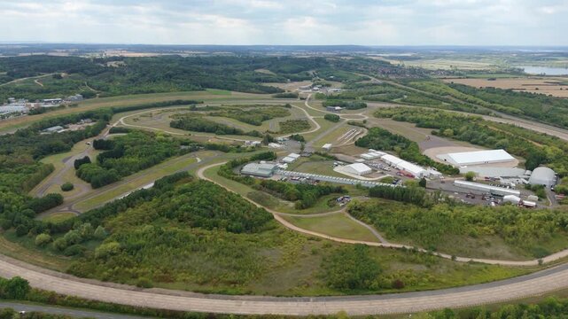 Aerial view of the Millbrook Proving Ground, a vast complex of test tracks and facilities surrounded by lush green vegetation, Bedford, England, United Kingdom.