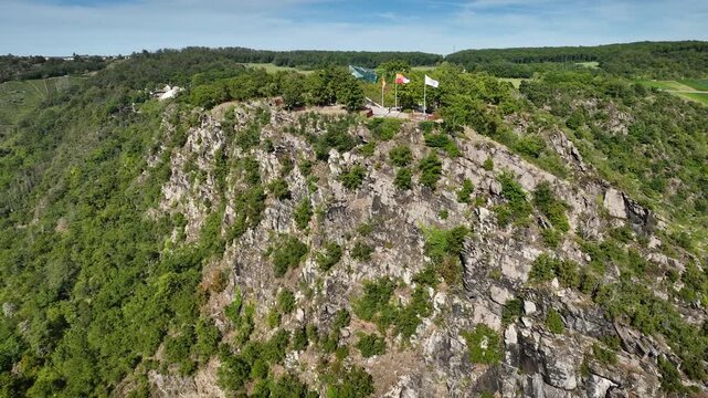Aerial footage of legendary Loreley cliff rising above the Rhine River in Upper Middle Rhine Valley, Rhineland-Palatinate, Germany. Aerial shot of striking slate rock Loreley near Sankt Goarshausen.