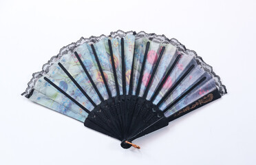 Kipas Tangan Motif Batik or hand fan Batik made of plastic and batik fabric. hand fan patterned batik isolated on white background.