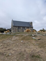 small stone church on lake shore