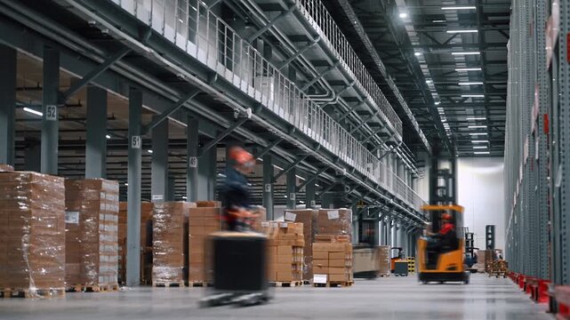 Time lapse footage of a dynamic working day at modern distribution center. Many workers on forklifts together move and transport various goods. Concept of efficient operation of the warehouse