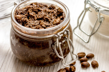 homemade coffe scrub in glass jar on wooden background