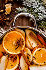 preparation of mulled wine in pot wooden background top view