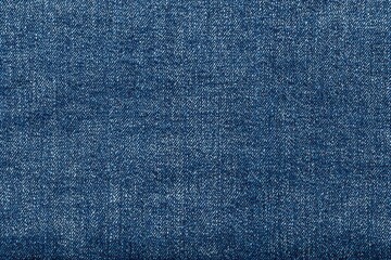 Naklejka premium Close-up of blue denim fabric texture, detailed and textured.