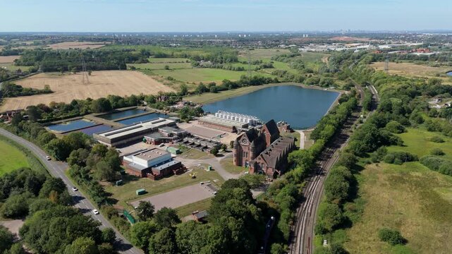 Aerial view of the Edgbaston Waterworks showing the contrast between the red brick buildings and the blue water reservoir, Birmingham, England, United Kingdom.