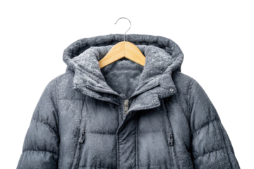 A dark grey winter puffer jacket, covered in frost, hangs on a wooden hanger, ready for severe cold weather. background removed