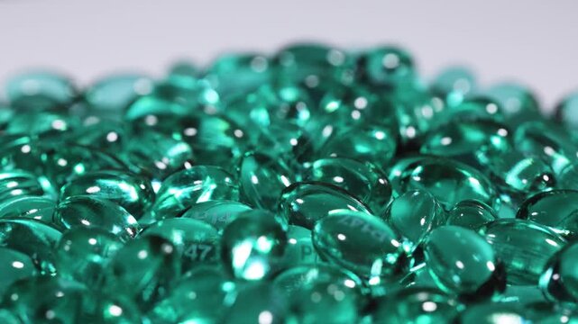 Blue green pill capsules isolated, analgesic pile, painkiller drugs, sedative pills group, medicine gel capsules on white background.