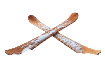 Two classic wooden skis, crossed and covered with fresh white snow, evoking winter sports and rustic charm. background removed