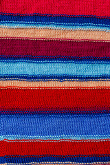 Obraz premium Knitted striped fabric texture, multicolor handmade textile background, stylish autumn winter clothing