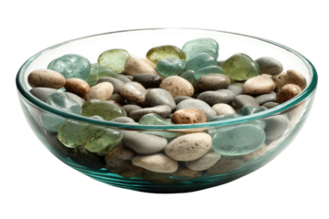 Glass bowl filled with an assortment of polished river stones and colored sea glass, including shades of green, blue, and brown. background removed