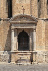 Fototapeta premium Chiesa di San Francesco Church Exterior Detail with Closed Window, Pediment and Columns in Ascoli Piceno, Italy