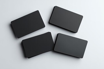 Four black business cards, slightly overlapping, on a light gray background