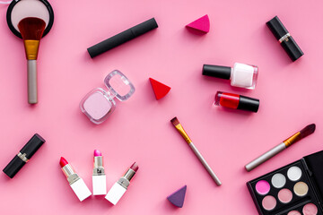 Flatlay of makeup cosmetics on pink background. Blusher, mascara and lipstick, top view
