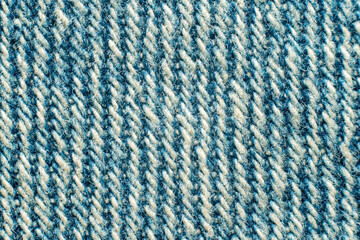 Detail macro view of light blue denim with visible fibres and diagonal weave of threads