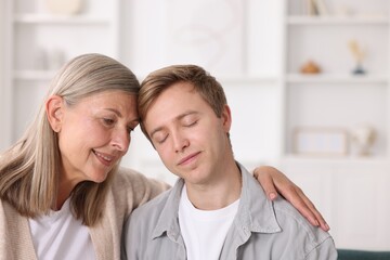 Happy mother and her son at home. Space for text