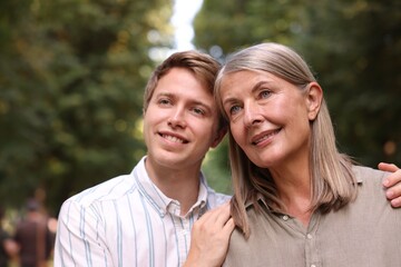 Fototapeta premium Smiling mother and her son outdoors. Family bonding