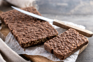 Traditional pieces of delicious Christmas chocolate nougat on wooden table. Copy space