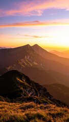 Scenic Mountain Range at Sunset with Golden Light and Wildflower Meadow in the Foreground with Orange and Purple Hues and Soft Focus