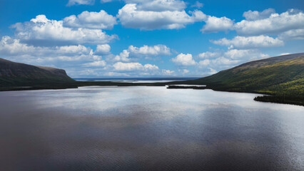 A large body of water with a blue sky in the background