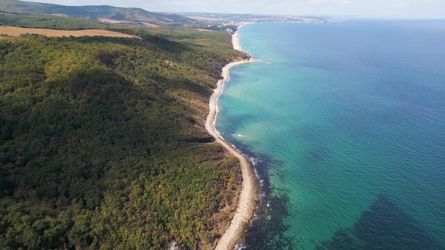 Aerial view of wild Bulgarian coastline with turquoise sea and green forested cliffs, scenic untouched nature and beautiful seascape