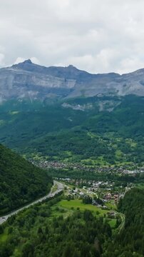 Vertical drone shot of the Servoz town, summer day in Haute-Savoie Alps, France