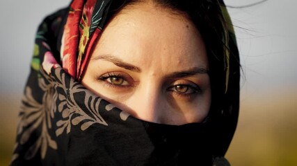 Beautiful muslim woman with hijab looking into camera