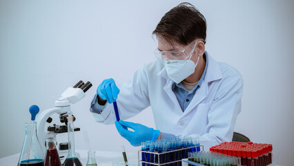 Medical researcher, chemist, examines samples under a microscope, pharmaceutical focus in lab coat, analyzes test tubes in work area.