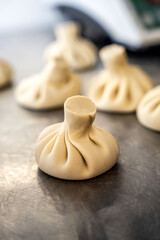 Raw Georgian khinkali dumpling on kitchen table