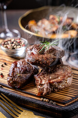 Hot grilled beef medallions with rosemary and pepper
