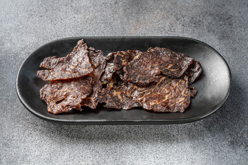 Beef jerky on black plate